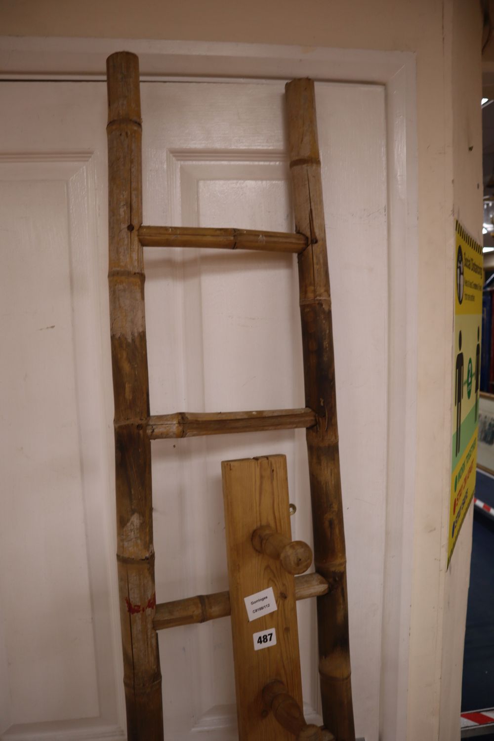 An unusual tapering bamboo seven tread step ladder, 6ft 6in., and a pine wall hanging coat rack